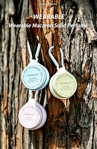 TOORUNE macaron wearable solid perfume with carabiner clip, pastel blue, mint green and lavender purple three colors hanging on tree bark, portable long-lasting solid fragrance balm